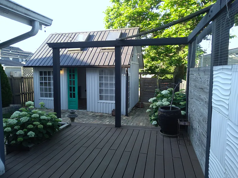 Back deck with view of back gate. Back gate leads to parking area.