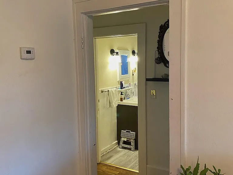 Hall looking into the Bathroom. New White Trim. Digital Thermostat. Linen Closet off of Bathroom.