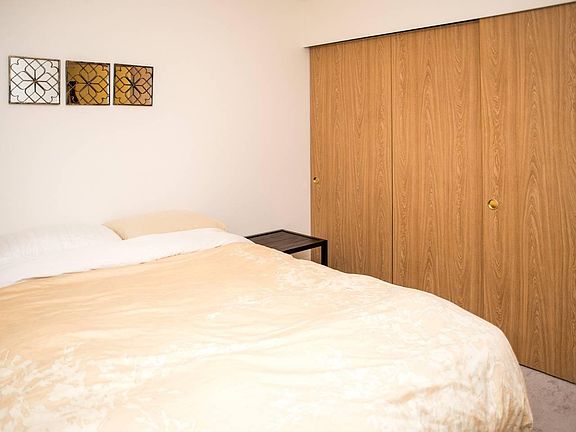 queen bed in a large bedroom