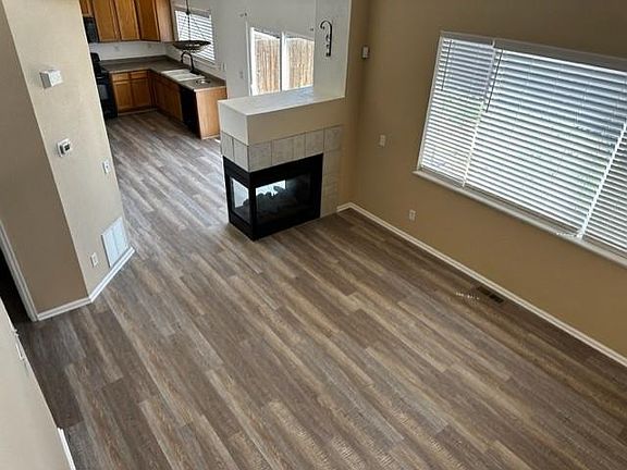 Living room with gas fireplace, dining room, and kitchen with new lvp flooring, and new , new blinds