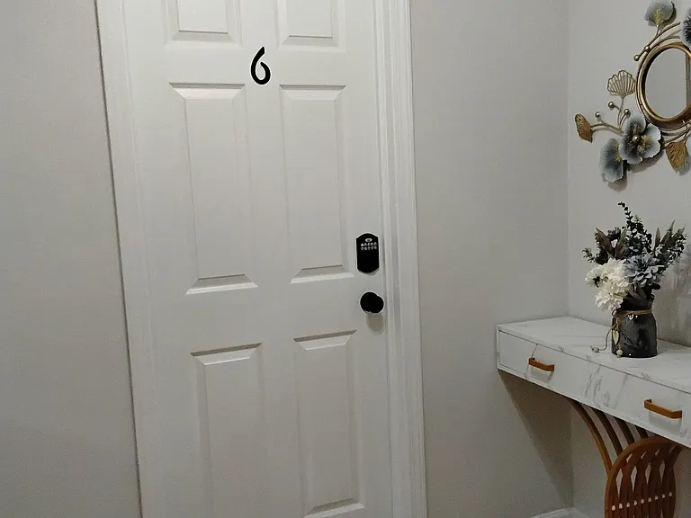 Entry area with secure door access, hardwood-style flooring, and a convenient console table for daily essentials.