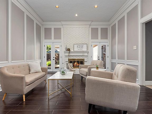 1 of 2 living areas, and the heart of the home, this one resides on the 1st floor and offers a convenient and stylish means to entertain guests. French doors lead to your private resort-style backyard. A beautiful mantle and gas fireplace serve as th