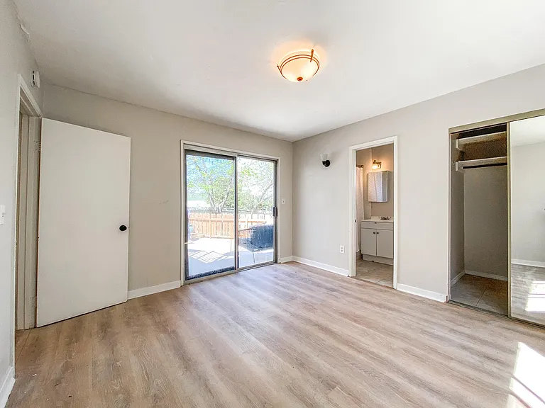 This is such a nice master bedroom. Take a peak out those doors!