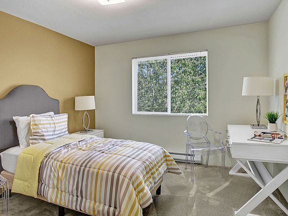 Bedroom with bed, desk, and window