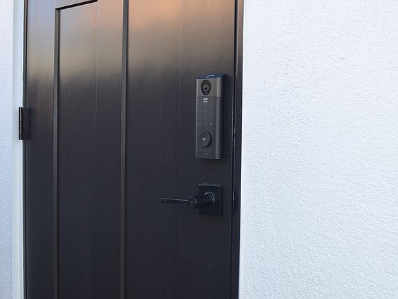 Entry door with mail slot and code entry deadbolt lock.