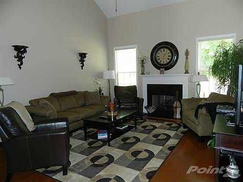 Living Room with Hardwood Floors, Fireplace with Gas Logs and a Cathedral Ceiling
