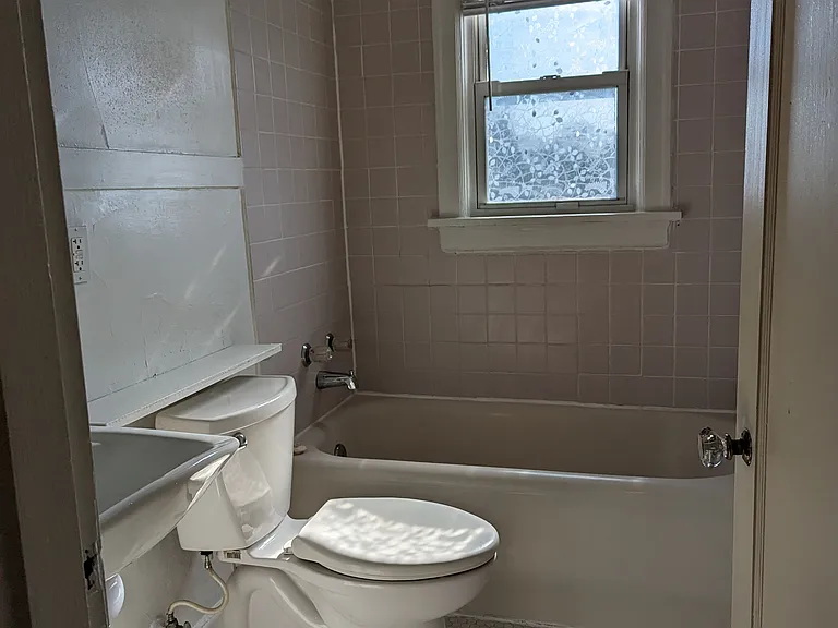 Ensuite walk in closet to your restored, large full bathroom with original beehive tile!