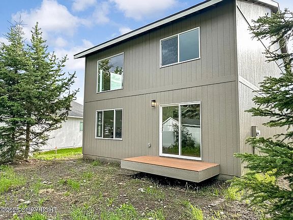 back deck accessible through the sliding door/back side of the house facing private backyard (not fenced)