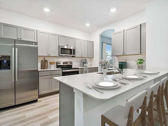 Juno new construction home plan interior spacious kitchen area at Lanier Acres in Zephyrhills, FL by