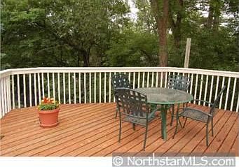 Deck overlooks Wooded Landscaped Lot..