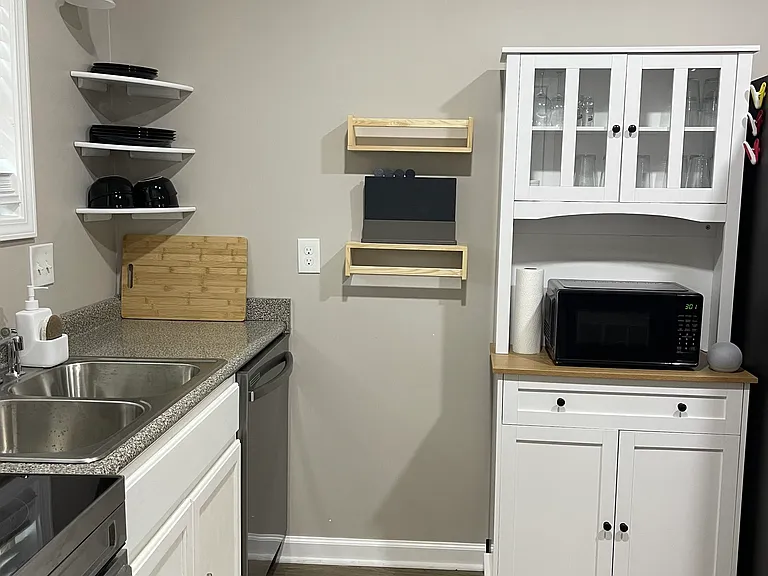 Sink and cabinet next to fridge