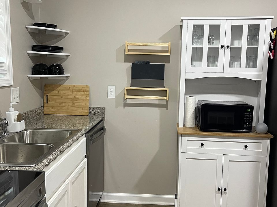 Sink and cabinet next to fridge
