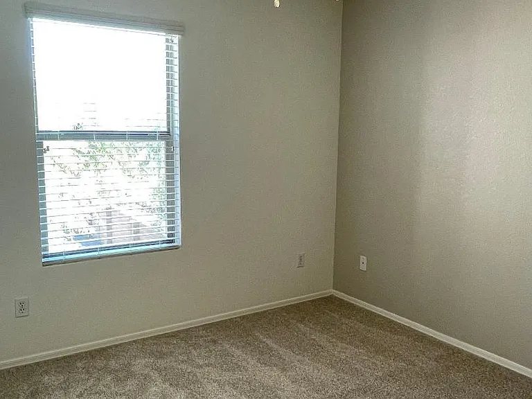 Generous Kid's rooms with ceiling fan and accent wall