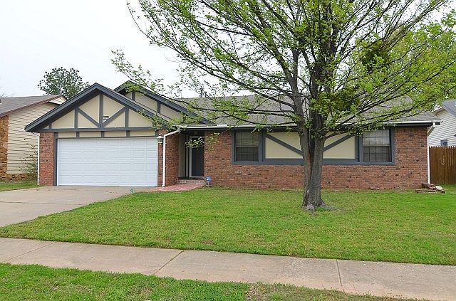 Brick home on lot with mature trees