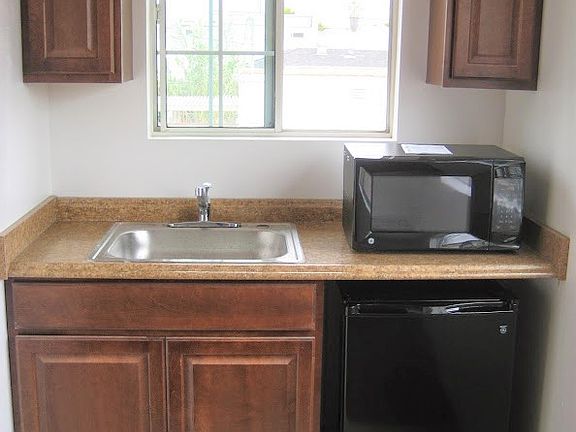 Great condition mini kitchenette. Includes refrigerator, electric hot plate, air fryer, and oven.