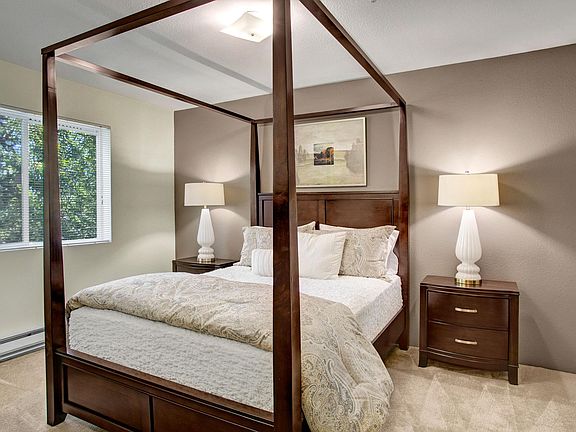 Bedroom with bed, desk, and window