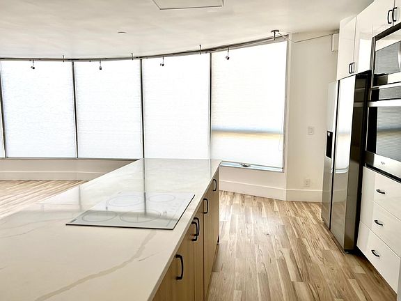 Kitchen/ living room with window shades drawn.