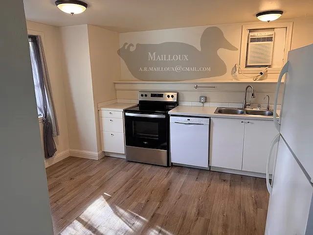 Kitchen with dishwasher, electric stove range, A/c, and full size refrigerator.