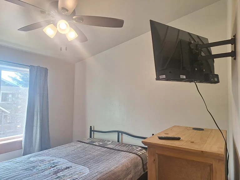 Middle bedroom chest, full size bed and mounted 32" television.