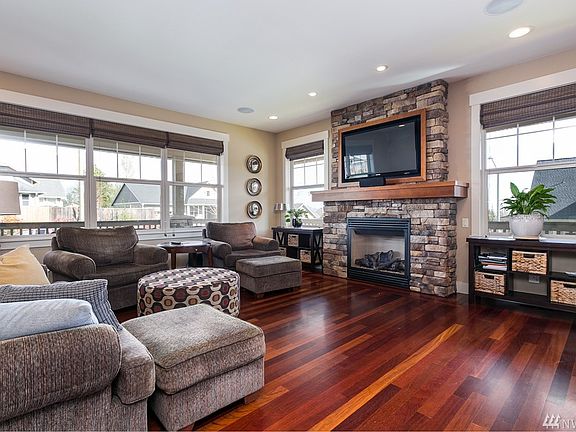 Spacious and sensational living room has plenty of natural lighting from the large view windows