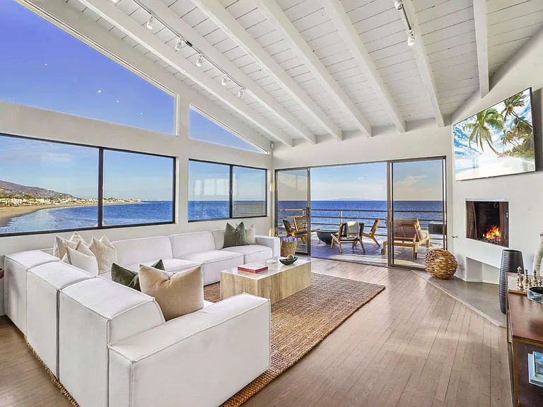 Relax by the fireplace, the perfect spot for unwinding after a day by the sea.