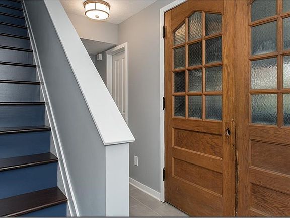 Hallway at the Front and Garage Door entries with two closets and the Library/Media Room
