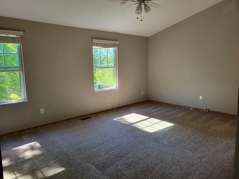 Large master suite with vaulted ceilings and ceiling fan.