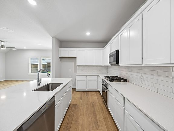 Kitchen in the Oscar home plan by Trophy Signature Homes - REPRESENTATIVE PHOTO