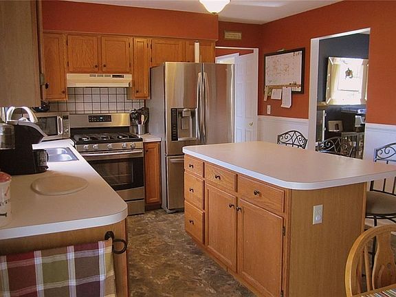 Shot from this angle you can appreciate all the fabulous workspace, plenty of oak cabinetry, and the easy flow into the Formal Dining Room.
