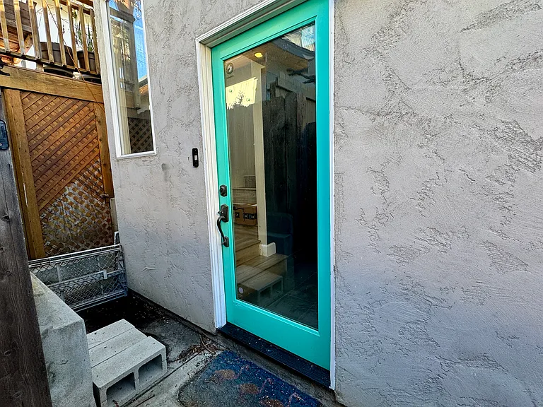 Front door on side behind gate for ultimate privacy