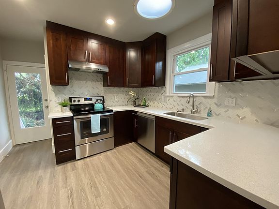 Kitchen with Quartz Countertop , designer backsplash and stainless steel appliances