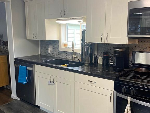 Newer white cabinets countertops stainless steel appliances and new fixtures throughout