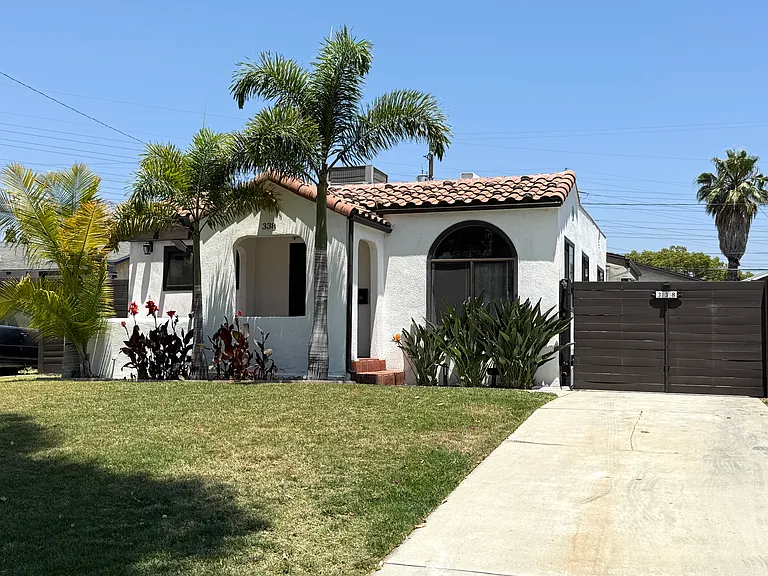 Front of house with a covered entry porch and a long private driveway with an automatic remote-controlled gate.