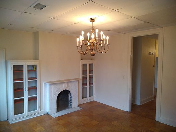 16' 5" x 14' 7" living room/dining room combo w/built-in bookcases, decorative FP, chandelier