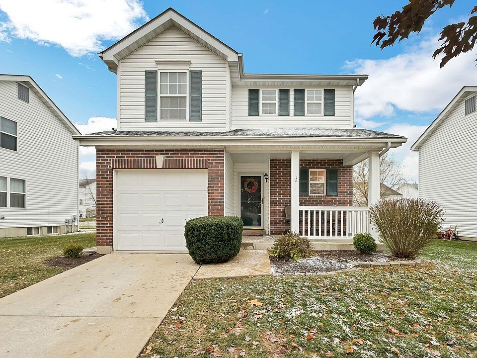 Beautiful curb appeal with brick front, covered patio, newer architectural shingle roof ('16) and maintenance free vinyl siding.