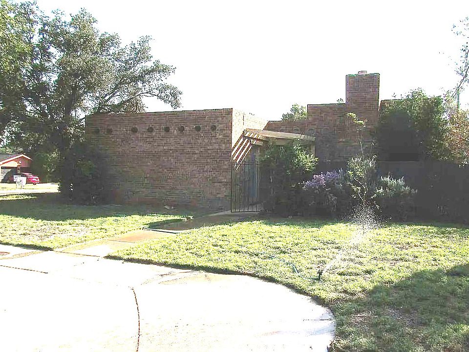 Front of house with circle driveway.