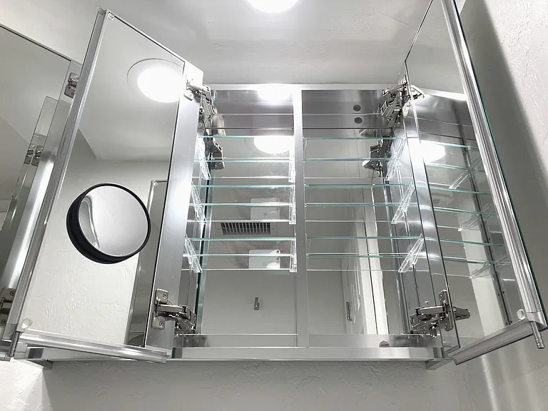 Bathroom cabinet mirrored interior. The bathroom lights are also dimmable.