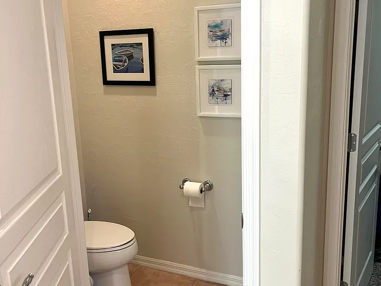 Enclosed toilet in primary en-suite bathroom.