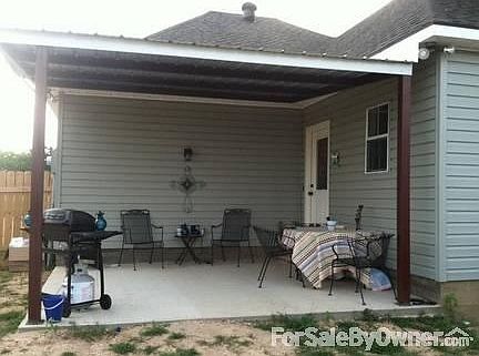 covered back patio with house entry