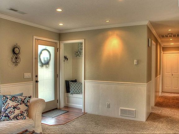 Entry : Bright front door with shoe storage bin and coat closet.