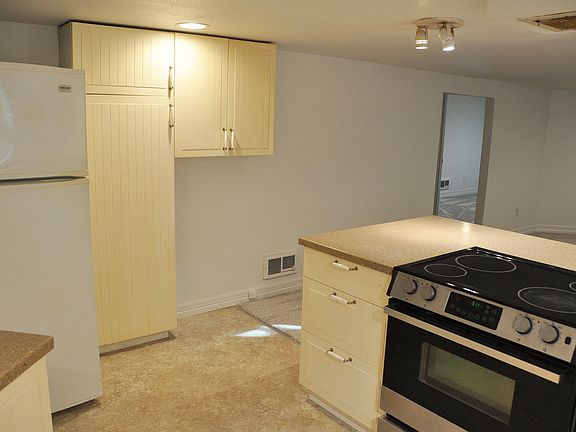 View standing in the kitchen looking to the refrigerator and more cabinets.
