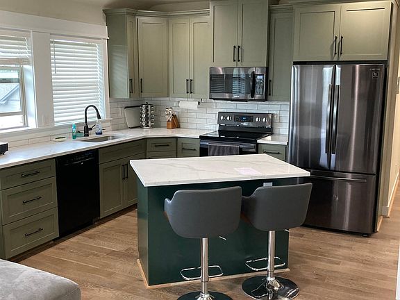 Brand new kitchen with brand new appliances, all electric two barstools, eating area and nice island