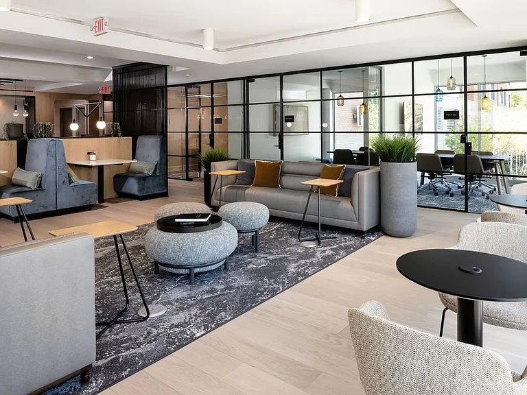 Lounge with multiple seating areas and work spaces
