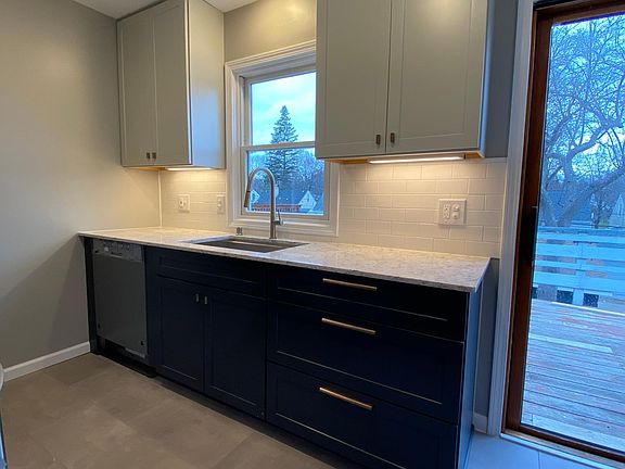Completely new kitchen with tile floor, solid surface countertops, new stainless appliances and under cabinet lighting!