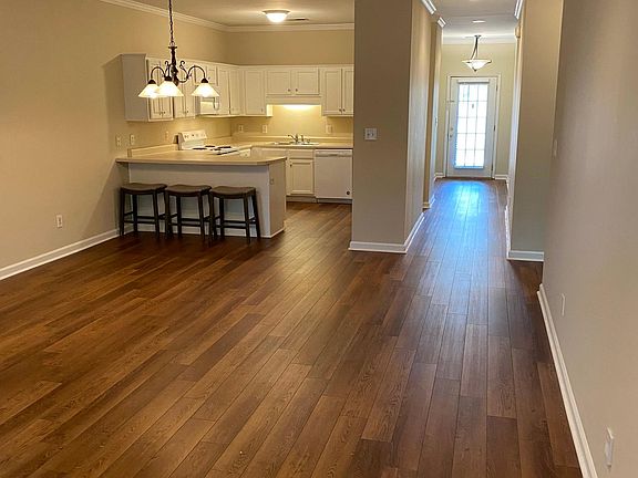 Main living area - kitchen, dining table area, and foyer hall