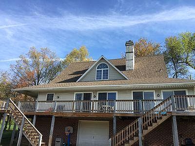 back of house showing porch & one car garage