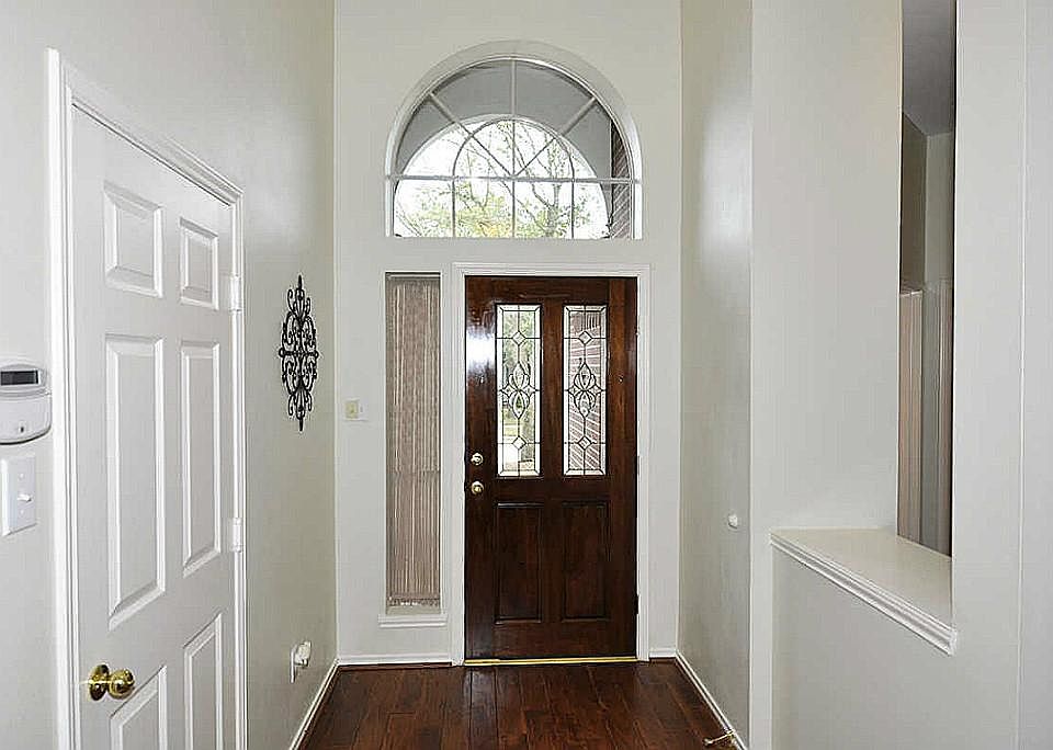Grand foyer with rich dark hardwoods.