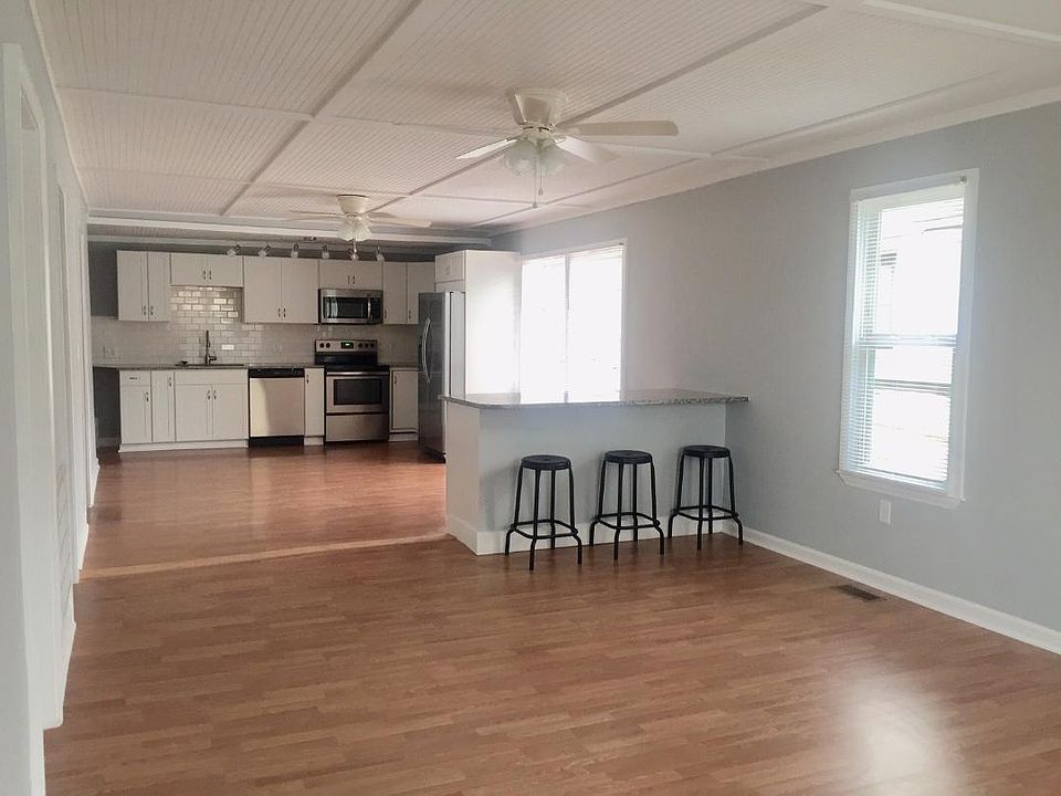 Open layout. Spacious family room leading into modern kitchen, all new appliances, subway tile backsplash, granite countertops and lots of natural light.
