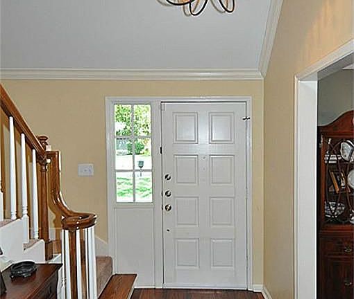 Wonderful vaulted entryway, beautiful floors, crown molding and chandelier.