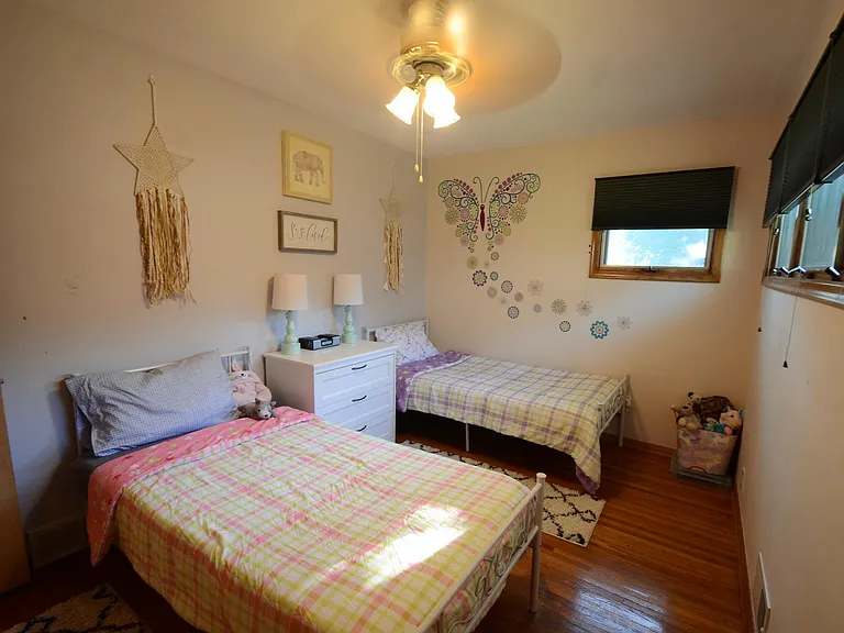 2nd Bedroom. Hardwood floors. Ceiling fan. Raised awning-style windows provide privacy and invite in the sunshine.